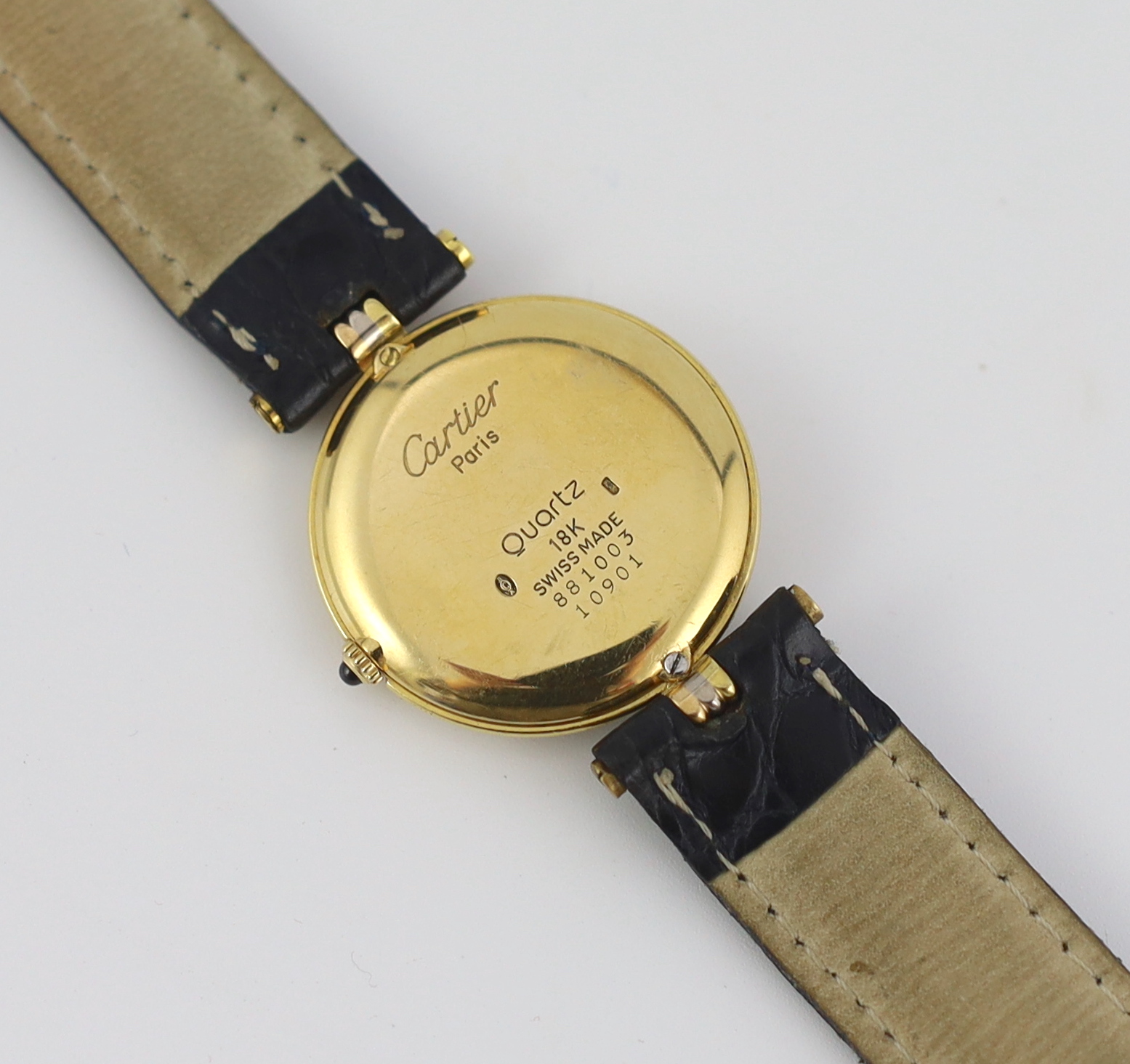 A lady's modern Cartier 18k gold quartz wrist watch, on associated leather strap and buckle